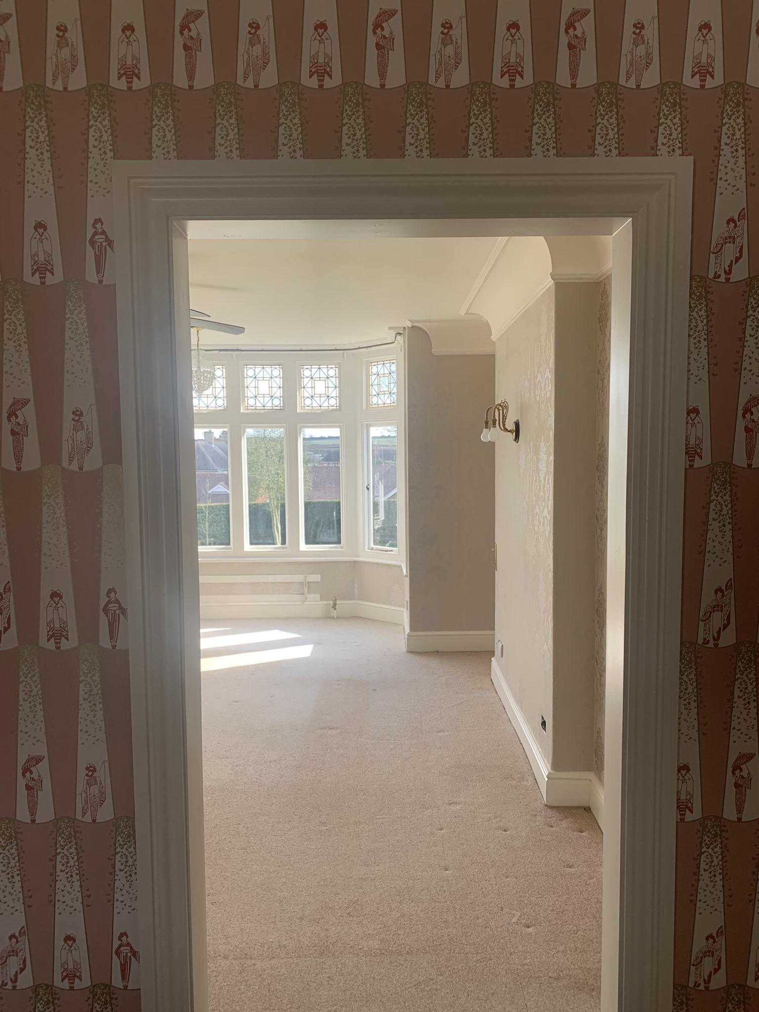 pink pattern wallpapered door